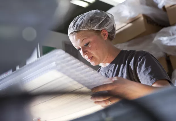 Woman working in a medical packaging plant.