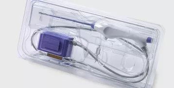 Medical scan device tray on a white table.